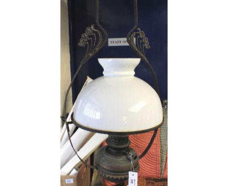 Floral design hanging single oil lamp burner with cream shade.