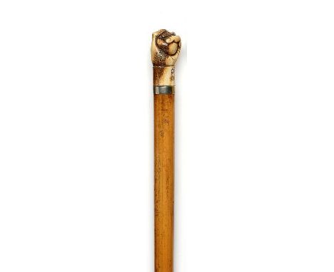 Walking sticks: A Malacca cane   early 19th century with clenched fist ivory top and mother of pearl cuff buttons above a met