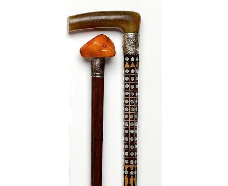 Walking canes: A rosewood stick  early 20th century inlaid with boxwood and mother of pearl and with horn handle and metal co