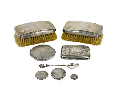 A selection of silver items. To include a George V cigarette case, pair of engine turned hair brushes, a compact, an 1887 Vic