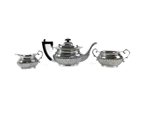 An Edwardian silver half fluted three piece tea set. Maker E.J.P., Birmingham 1906, weight 34 toz.The teapot might have had a