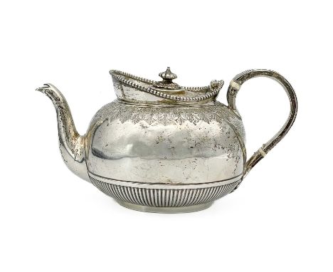 A Victorian silver bachelor teapot by Richard Martin &amp; Ebenezer Hall. Of ovoid form, the hinged lid over the stiff leaf e