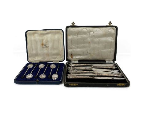 An Edwardian silver handled set of six fruit knives by William Hutton &amp; Sons. With shell and fruiting vine embossed fille