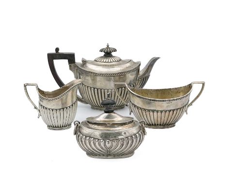 A Victorian silver three piece bachelor tea set by James Deakin &amp; Sons. Of half fluted form, comprising teapot, cream jug