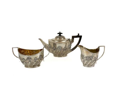 A Victorian silver three piece tea set by Charles Stuart Harris. Oval section, fluting and C scroll embossed decoration, comp