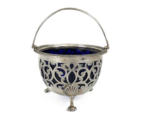 A Victorian silver swing handled basket with blue glass liner by Henry Wilkinson &amp; son. With peirced decoration, gadroone