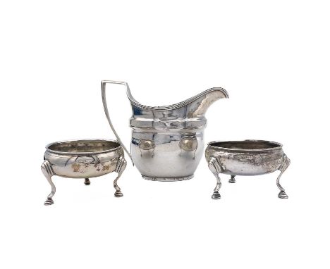 A George III silver cream jug. Of helmet form, with worn hallmarks, height 9.5cm; together with a pair of George III silver s