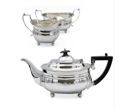 A three-piece silver tea set by C S Harris &amp; Sons Ltd. with gadrooned rims and angled handles, raised on four ball feet. 