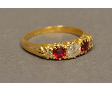 An 18 Carat Yellow Gold Diamond and Ruby Ring set with three diamonds and two rubies in a pierced setting 