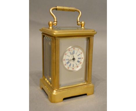 A French Brass Cased Miniature Carriage Clock, the silvered face with enamel dial, Roman and Arabic numerals and with lever e
