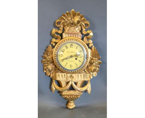 A Carved Giltwood Cartel Clock, the dial with Arabic numerals and two train movement, 62 cms long 