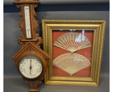 A 19th Century Fan, together with another similar within a single frame, together with an oak barometer/thermometer 