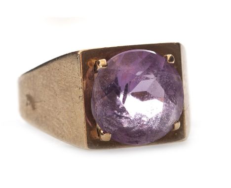 GEM SET RING, set with a round faceted purple gem 9.8mm diameter to a broad tapered shank, in nine carat gold, size I 1/2, 4.