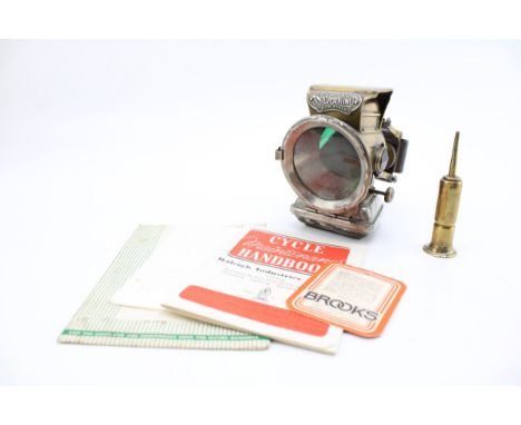Jos Lucas 'Silver King' bicycle lamp together with brass oiler and Raleigh Cycles Maintenance Handbook. (3)