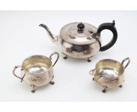 Silver plated hammered tea set to include teapot, milk jug and sugar bowl (3).