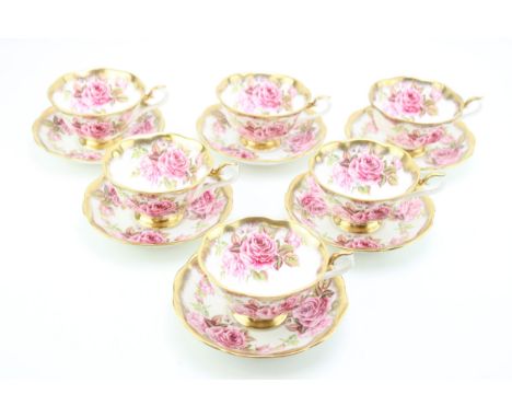 Six Royal Albert cups and saucers, gilt decoration, with pink rose / cabbage rose decoration (12).  In good condition with no
