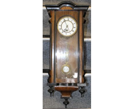 A Vienna wall clock, white ceramic dial, original key and pendulum, height 78cm.