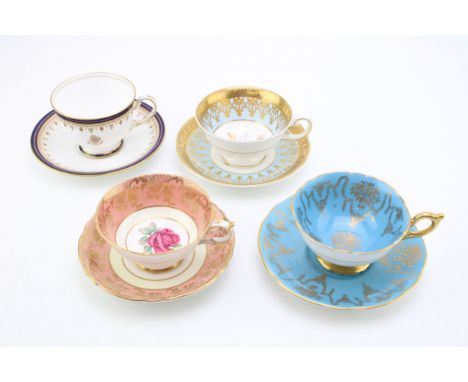 A Paragon cup and saucer, cabbage rose design, a Royal Grafton cup and saucer with pink rose design, a Coalport blue and gilt
