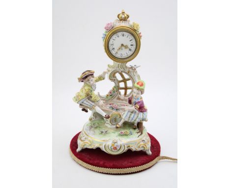 Reine Handarbeit continental pottery mantle clock of a romantical scene, on period velvet pad, 33cm tall.  Displays well, par