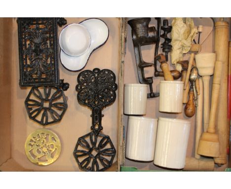 A collection of kitchenalia items to include rolling pins,. stoneware jars, trivets and other similar items. (Qty)