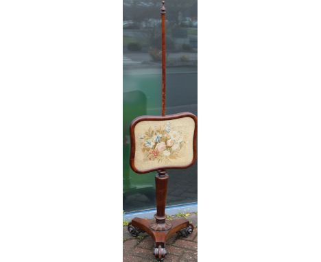 A Victorian carved mahogany pole screen with embroided floral panel, height 148cm.