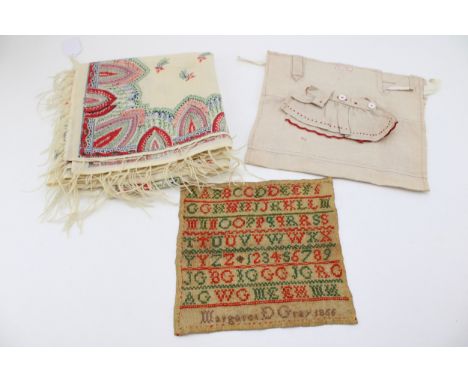 A 19th century sampler on linen, by Margaret Gray, dated 1866, a cream Paisley wool shawl, with fringed edge and an early 20t