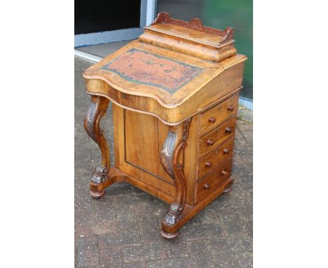 A c19th Victorian walnut Davenport desk with four side drawers with cabriole legs on casters with satin wood interior  The it