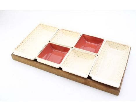 A Susie Cooper Hors D'oeuvres Set on Wooden Tray, 49cm wide.  In good condition with no obvious damage or restoration.Provena