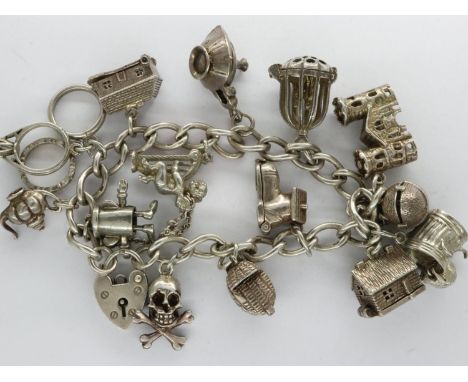 Hallmarked silver charm bracelet with hallmarked silver padlock clasp and fourteen charms, L: 16 cm, 63g. UK P&amp;P Group 1 