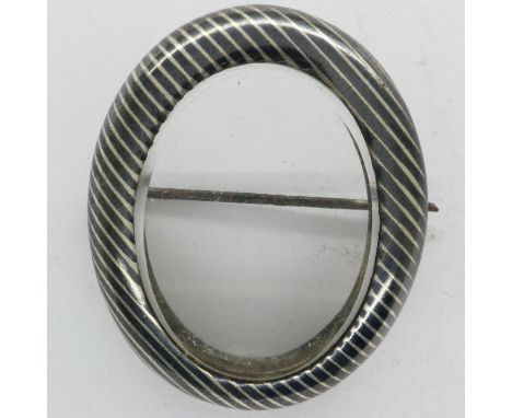 Antique unmarked silver and niello enamel oval shaped brooch with glass centre panel, 30 x 35 cm. UK P&amp;P Group 1 (£16+VAT