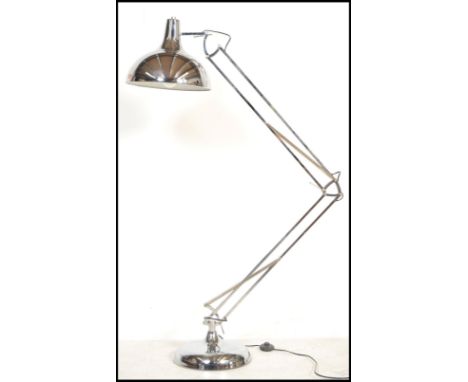 A vintage 20th century floor standing anglepoise style lamp raised on a circular base with conical pendant shade and chrome f