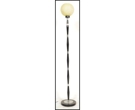 A retro mid century, circa 1960's standard lamp - floor lamp of ebonised finished being raised on a turned base with turned c