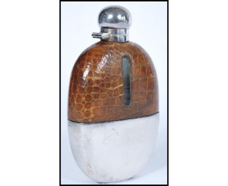 A vintage 20th century silver plated and crocodile skin hop flask of larger form. The oval glass body having removable silver