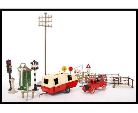 A collection of antique toys and related items to include; Brimtoy tin plate tow truck , Tri-Ang Minic tow along caravan alon
