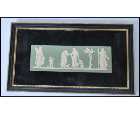 A framed Wedgwood jasper ware / cameo ware wall plaque, on a green ground having raised white figures depicting a classical s