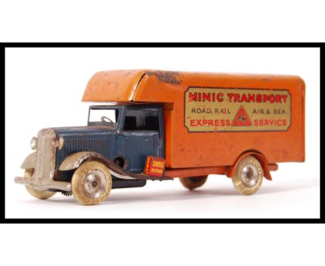 A vintage original Tri-Ang Minic Toys tin plate clockwork&nbsp; ' Minic Transport ' lorry in orange and blue with notation to