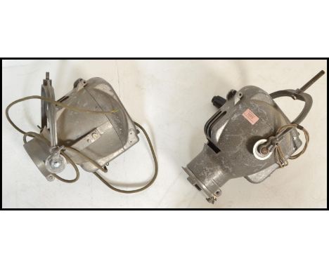 A pair of vintage 20th Century theatre / stage lights possibly by strand lighting of usual form, hanging brackets to the top.