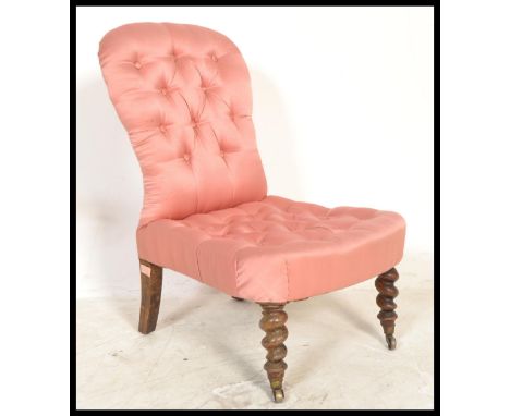 A 19th Century button backed mahogany&nbsp; nursing chair having barley twist legs with brass casters, and pink satin upholst