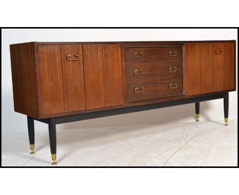 A vintage mid 20th Century G - Plan E Gomme Tola sideboard / credenza, twin bi - fold doors flanking a run of three drawers, 
