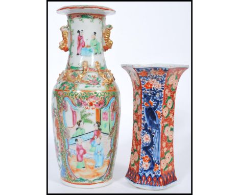 A 19th century Canton enamel vase having famille rose and verte decoration with white cartouche panels depicting birds flower