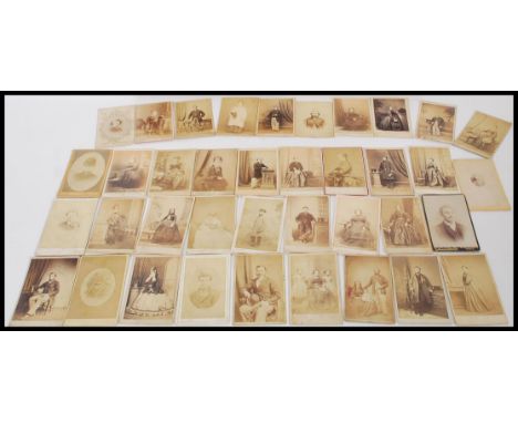A collection of 19th century Victorian CDV portrait photographs held within a Sample photo box.