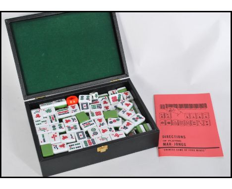 A 20th century Chinese Mahjong set in fitted case having white and green stone playing pieces. Measures 8cm-high 24cm-wide 18