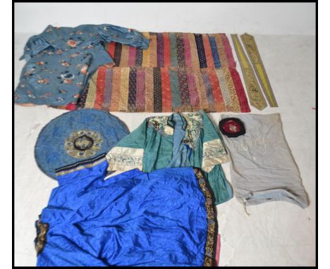 A collection of 19th century Chinese clothing to include a blue silk shirt with flowers and butterflies, green shirt depictin