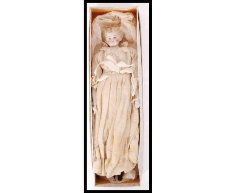 A antique possibly German bisque porcelain doll in a period attire within the original box. Measure; 28cm.&nbsp;