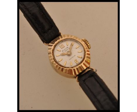 A 20th Century ladies Aviva 9ct gold cased cocktail watch having baton markings to the chapter ring and a faceted design to t