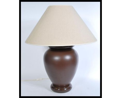 A contemporary 20th century French FDC ceramic large table lamp raised on a bulbous circular foot with brown glaze and conica