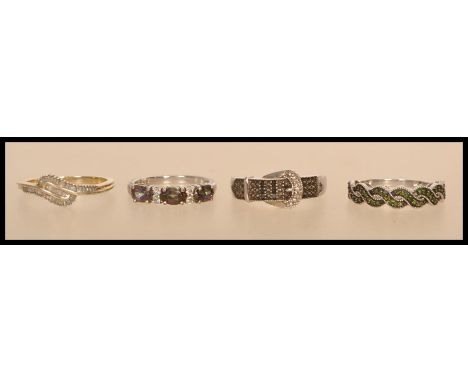 A selection of silver and white metal rings to include a stamped 925 buckle ring with inset black and white stones (size S), 
