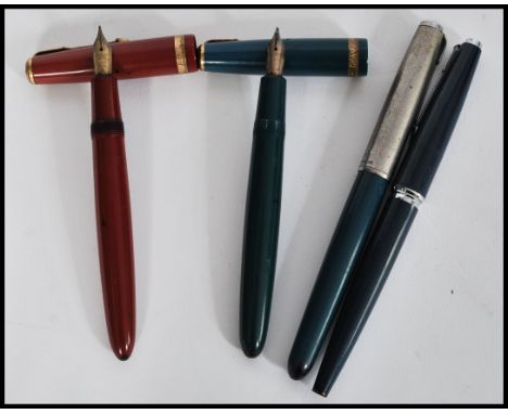 A collection of four vintage 20th Century Parker Fountain / Ink pens to include a Parker Duofold with 14K nib, Parker 585 wit