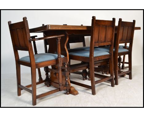 A large Ercol solid oak refectory extending dining table together with a matching set of 6 dining chairs. The chairs to inclu