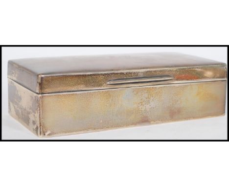 An early 20th century Edwardian George V silver hallmarked table cigarette box with a pine lining and a slightly domed hinged